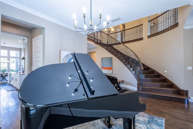 interior space with dark hardwood / wood-style floors, ornamental molding, and a chandelier