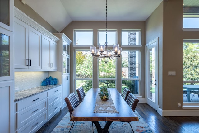 dining space with dark hardwood / wood-style flooring and a notable chandelier