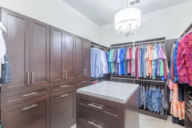 spacious closet featuring an inviting chandelier