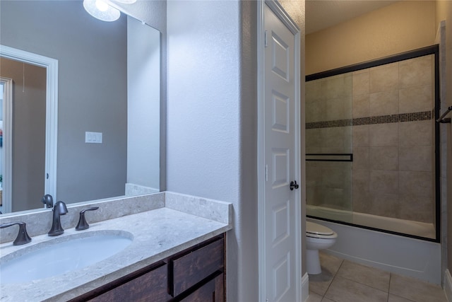 full bathroom with toilet, combined bath / shower with glass door, tile patterned flooring, and vanity