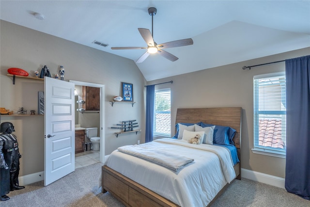 bedroom with light carpet, ceiling fan, lofted ceiling, and ensuite bath