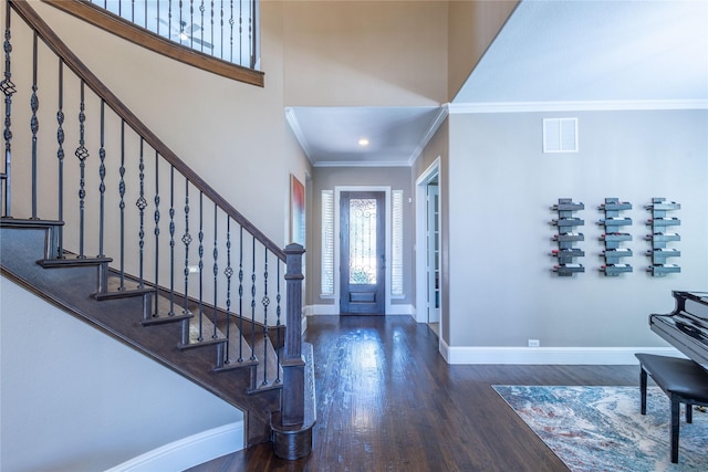 entrance foyer featuring dark wood-type flooring and crown molding