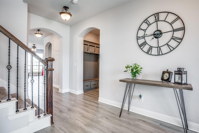 entrance foyer with ceiling fan and light hardwood / wood-style flooring