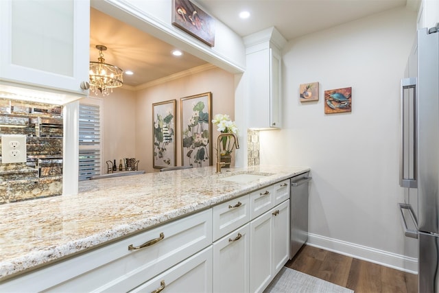 bar with light stone countertops, appliances with stainless steel finishes, dark wood-type flooring, white cabinetry, and sink