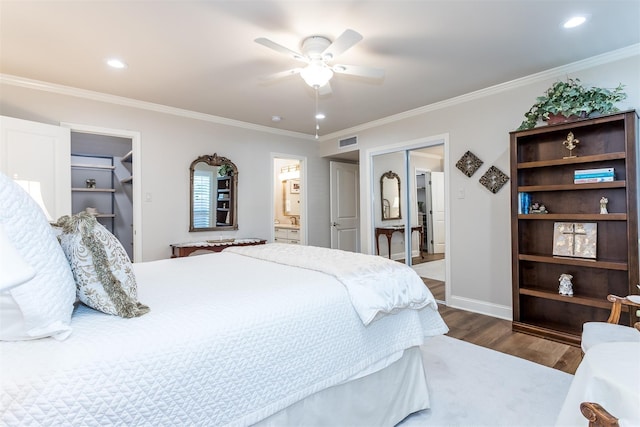 bedroom featuring ceiling fan, dark hardwood / wood-style floors, connected bathroom, ornamental molding, and a closet