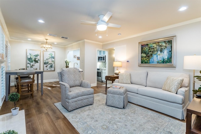 living room featuring ceiling fan with notable chandelier, crown molding, and hardwood / wood-style flooring