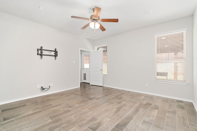 spare room with ceiling fan and light hardwood / wood-style flooring