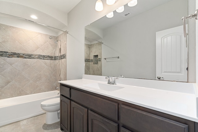 full bathroom with toilet, tiled shower / bath combo, and vanity