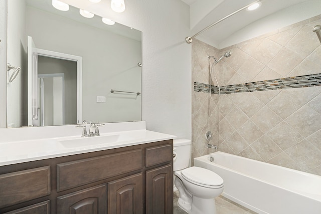 full bathroom featuring toilet, tiled shower / bath, and vanity