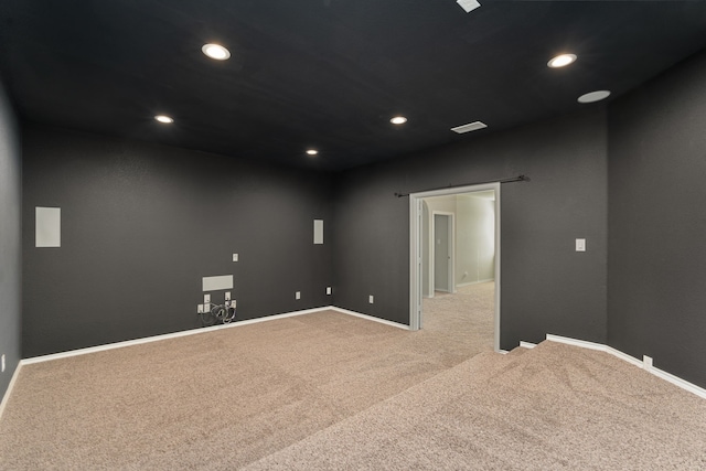 unfurnished room featuring light carpet