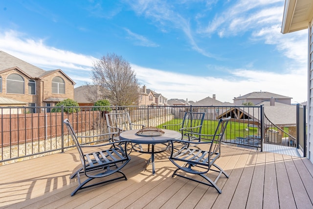 wooden deck featuring a yard and a fire pit