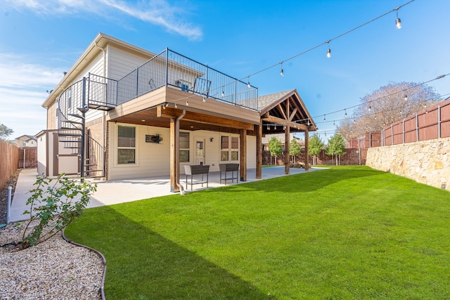 rear view of property with a lawn and a patio