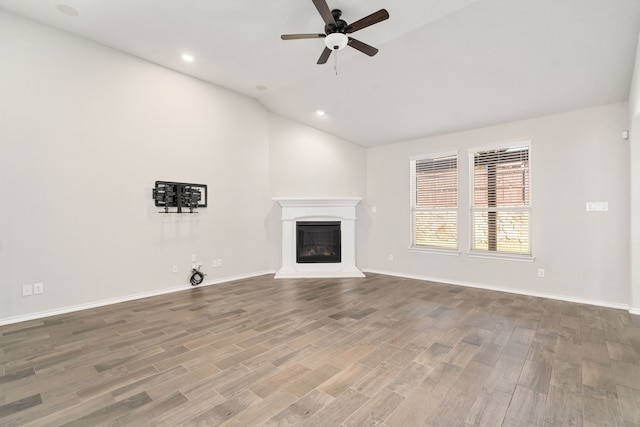 unfurnished living room featuring ceiling fan, vaulted ceiling, and hardwood / wood-style floors