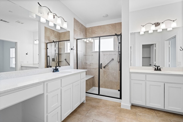 bathroom with vanity, tile patterned floors, and a shower with door