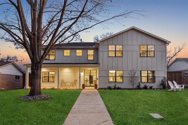 modern inspired farmhouse with a yard