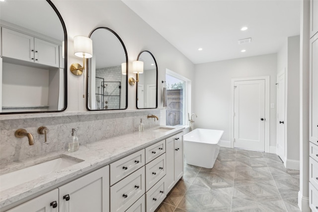 bathroom with shower with separate bathtub and vanity