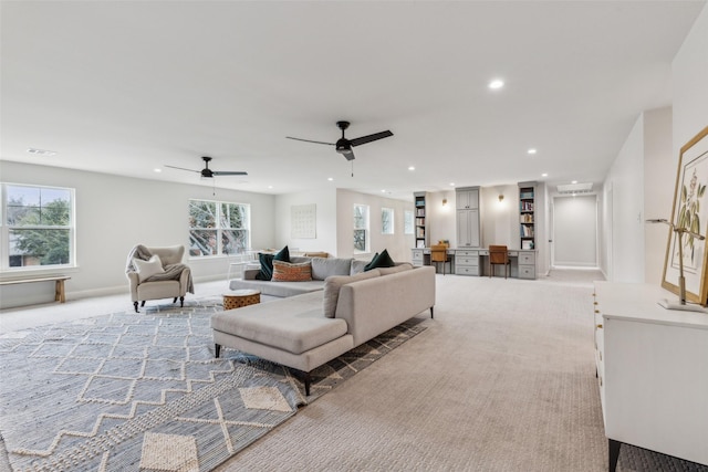 living room featuring light carpet and plenty of natural light