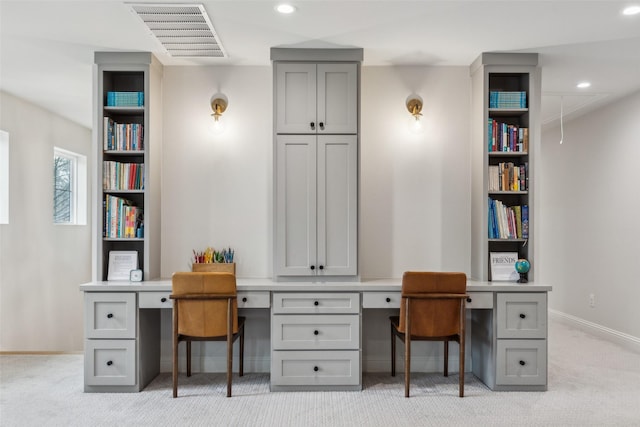 office space with light carpet and built in desk