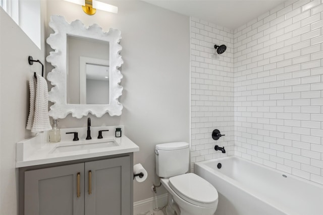 full bathroom with toilet, tiled shower / bath, and vanity