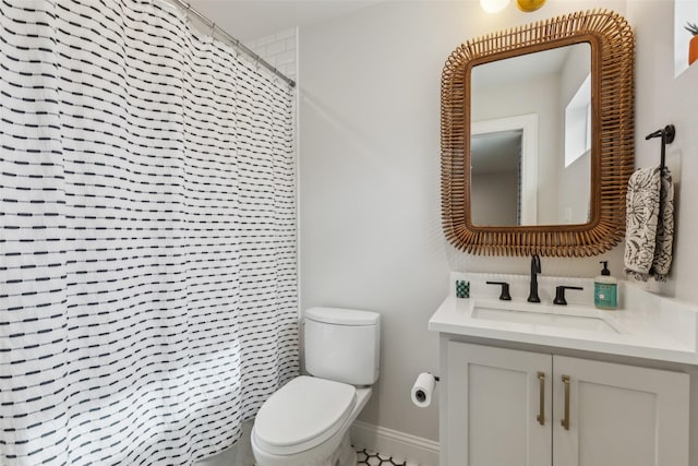 bathroom featuring toilet, a shower with curtain, and vanity