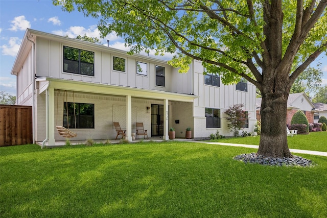 9736 Chiswell Rd, Dallas, TX 75238 - modern farmhouse featuring fence, board and batten siding, a front yard, and brick siding