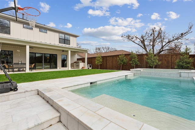 view of pool with a lawn and a patio