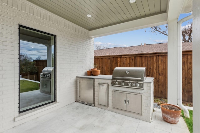 9736 Chiswell Rd, Dallas, TX 75238 - view of patio with area for grilling, grilling area, and fence