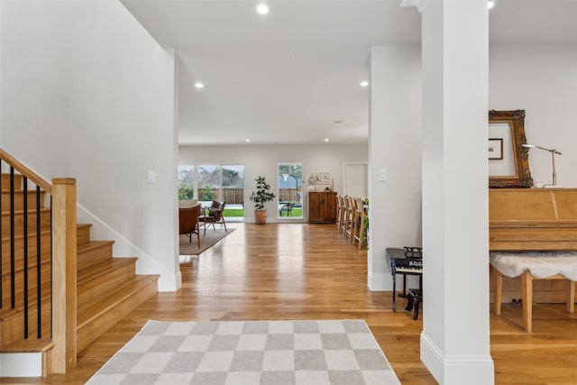 foyer with light wood-type flooring and ornate columns