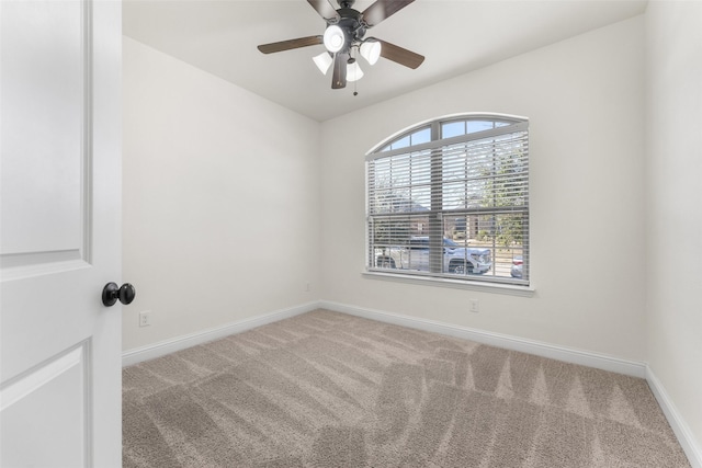 empty room with ceiling fan and carpet flooring