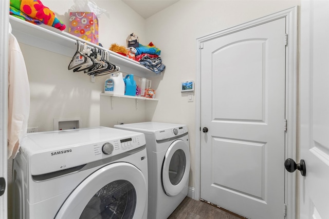 laundry area featuring washing machine and dryer and dark hardwood / wood-style floors