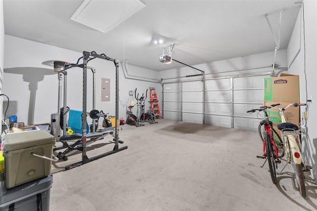 garage with a garage door opener and electric panel