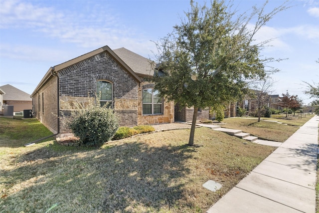 view of front of house featuring a front yard and central air condition unit