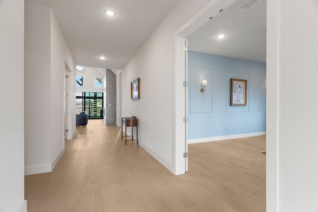 corridor with light wood-type flooring