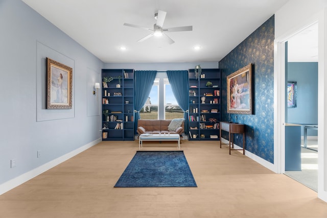 living area featuring ceiling fan and light wood-type flooring