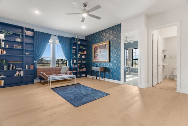 living area with ceiling fan and hardwood / wood-style floors