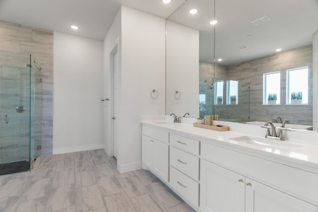 bathroom with vanity and shower with separate bathtub