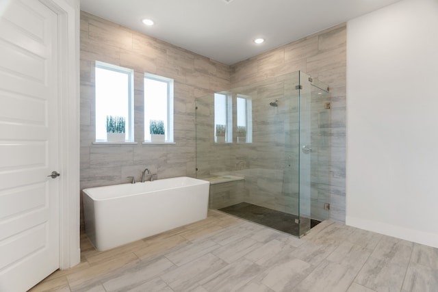 bathroom featuring separate shower and tub