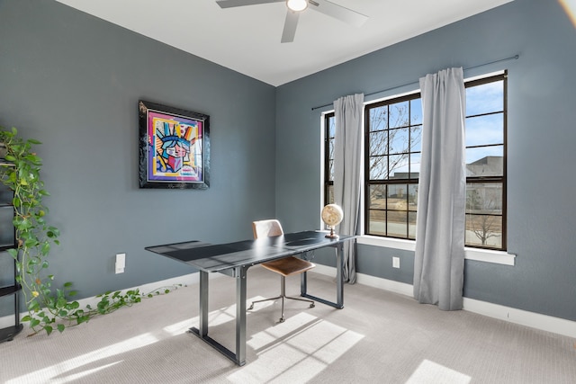 carpeted office space with ceiling fan and a wealth of natural light