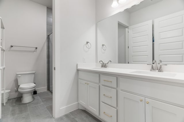 bathroom featuring toilet, tile patterned floors, walk in shower, and vanity