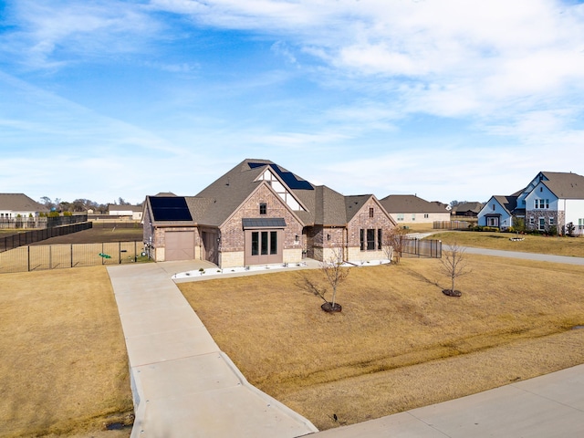 view of front of home with a front lawn and a garage