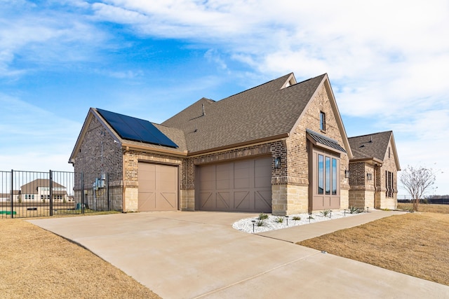 view of front of house with solar panels and a garage