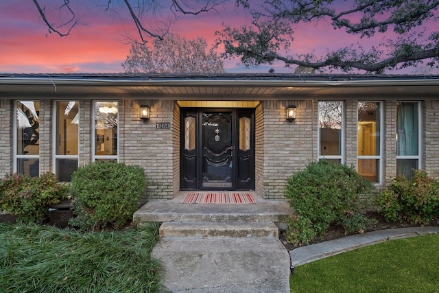 view of exterior entry at dusk