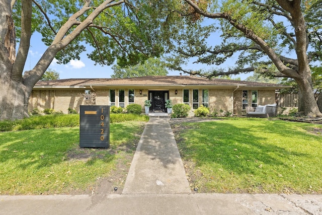 ranch-style home with a front lawn