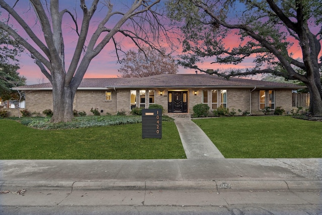 ranch-style house with a lawn