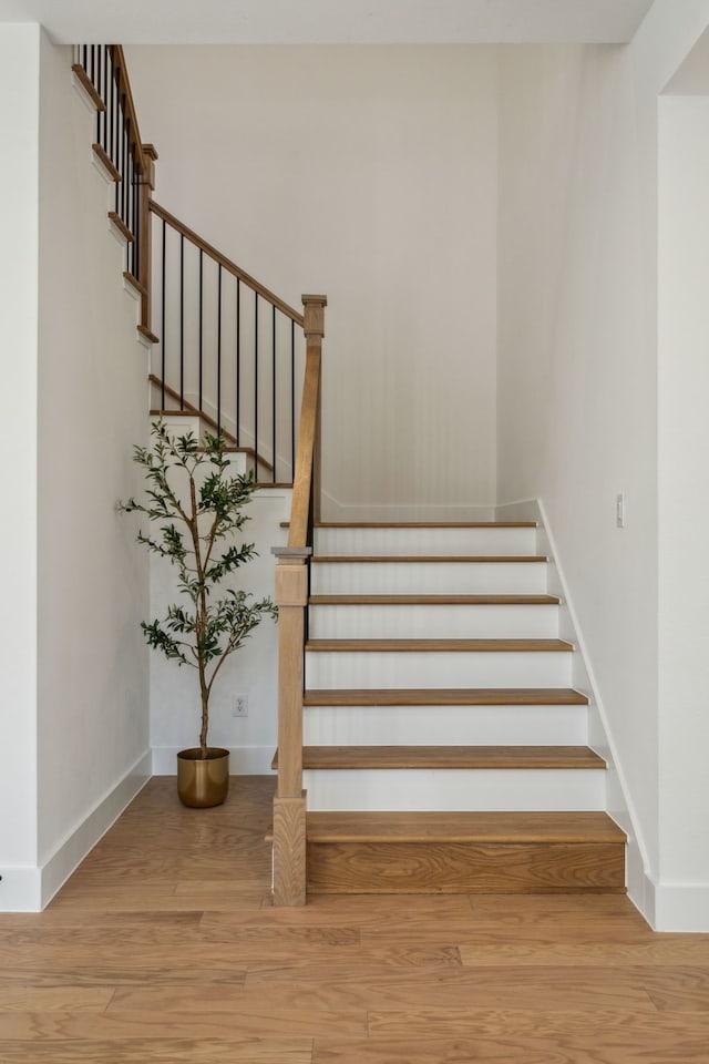 stairs featuring wood-type flooring