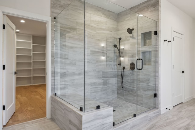 bathroom featuring wood-type flooring and walk in shower