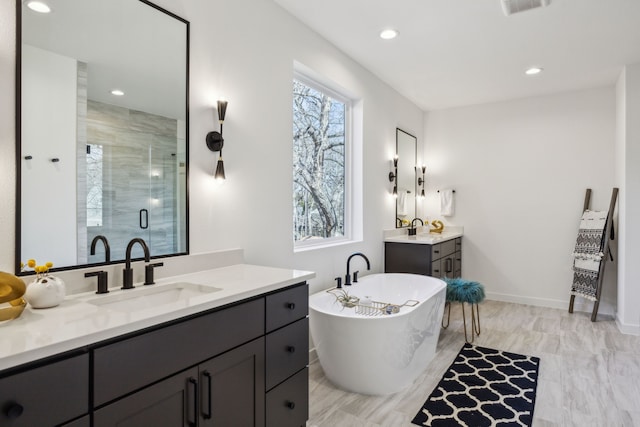 bathroom featuring independent shower and bath and vanity