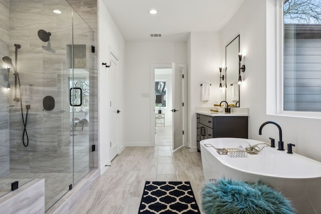 bathroom featuring vanity and independent shower and bath