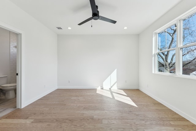 unfurnished room featuring ceiling fan and light wood-type flooring