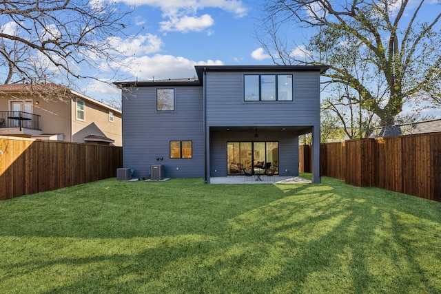 back of house with central AC unit, a lawn, and a patio